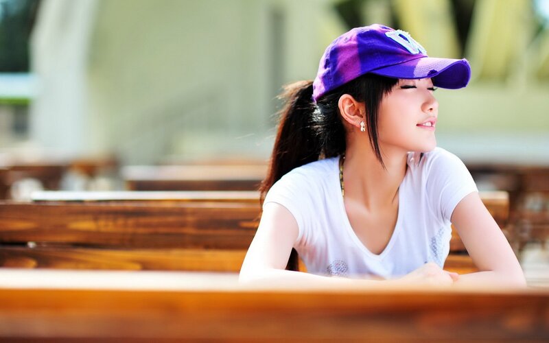 woman in purple cap sitting
