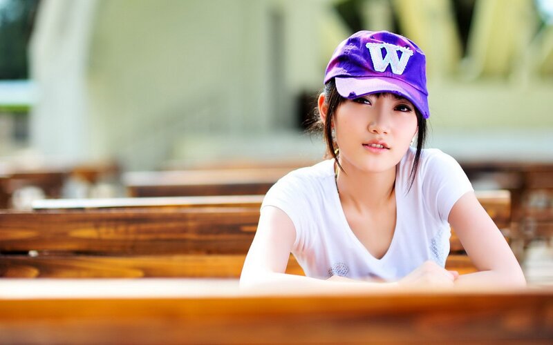 woman in purple cap sitting