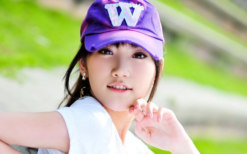 woman in purple cap smiling