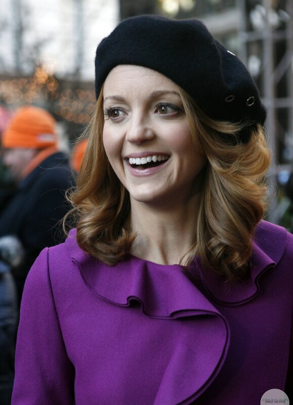 woman in purple coat smiling