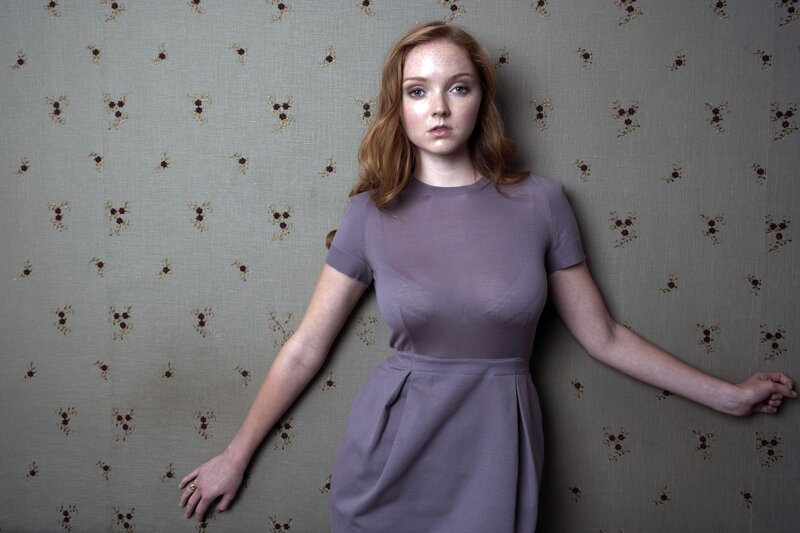 woman in purple dress against wallpaper