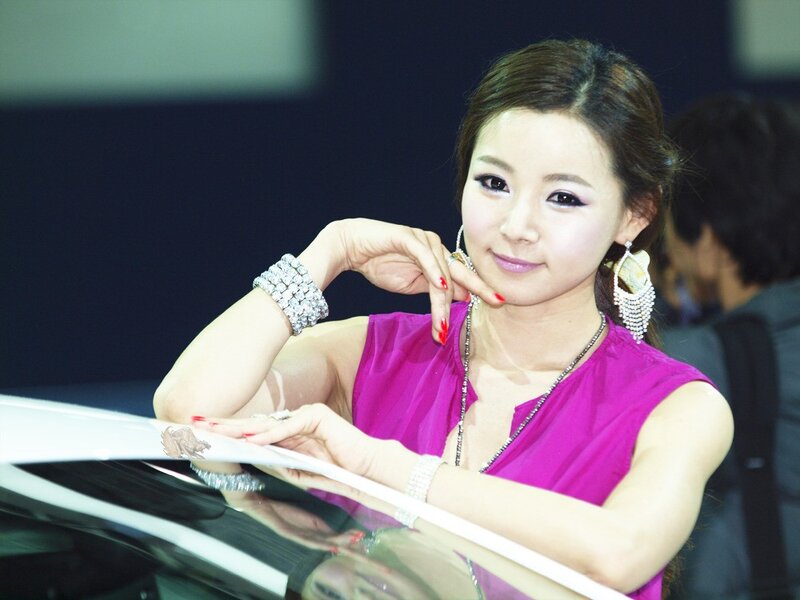Woman in purple dress at auto show