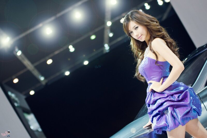 Woman in purple dress at auto show