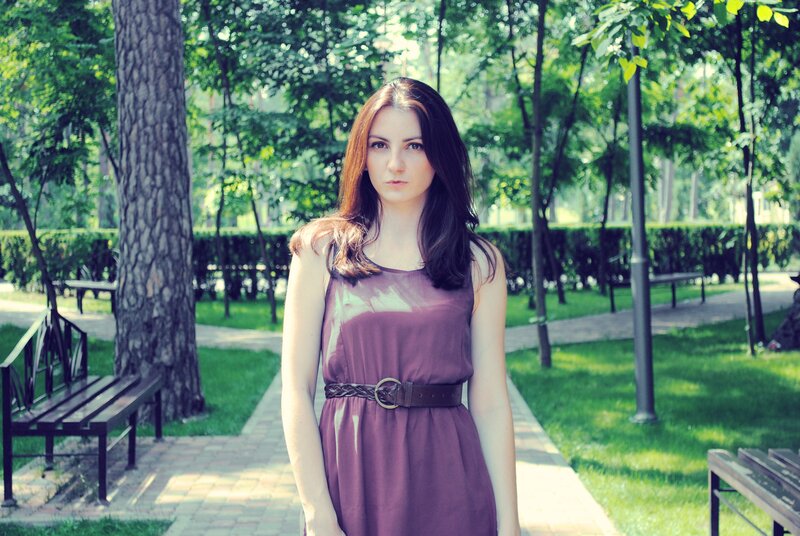 Woman in purple dress at park