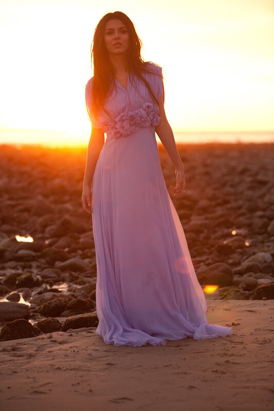 Woman in purple dress at sunset