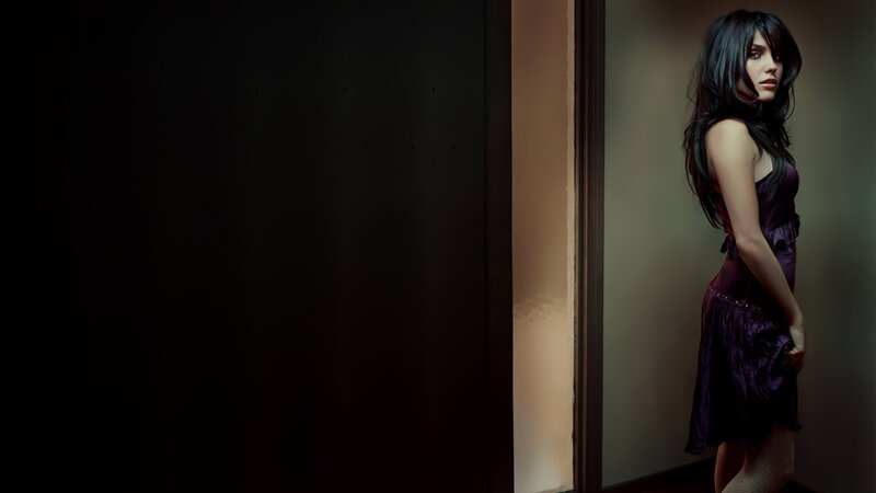 woman in purple dress by door