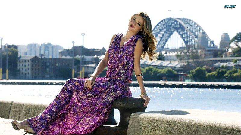 woman in purple dress by harbor