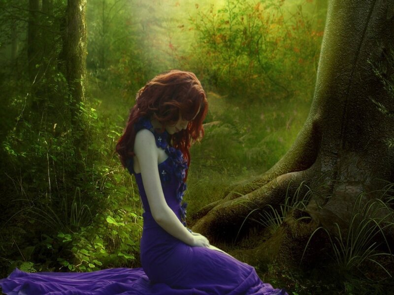 Woman in purple dress in forest