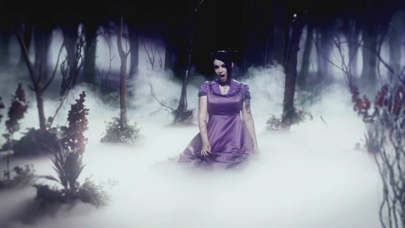 woman in purple dress in misty forest
