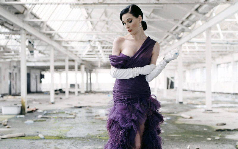 Woman in purple dress in warehouse