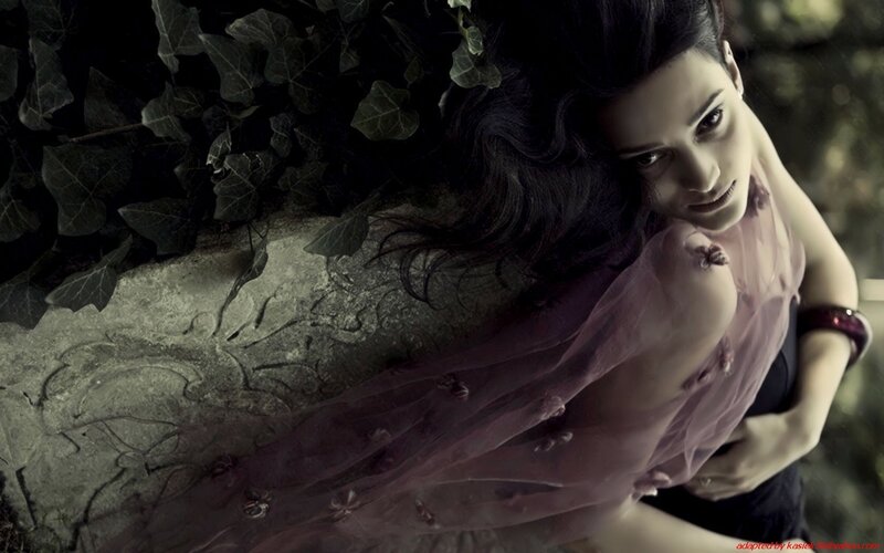 woman in purple dress lying on stone