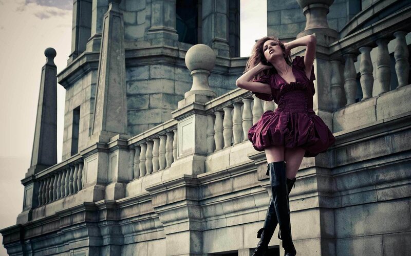 woman in purple dress on balcony