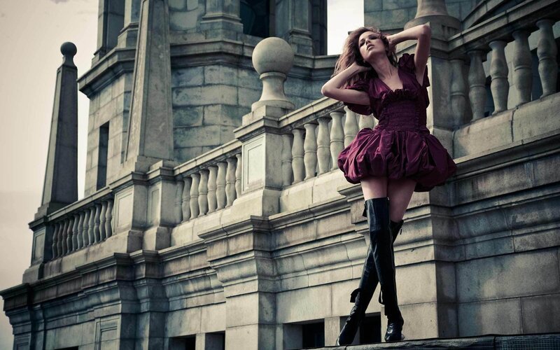 Woman in purple dress on balcony