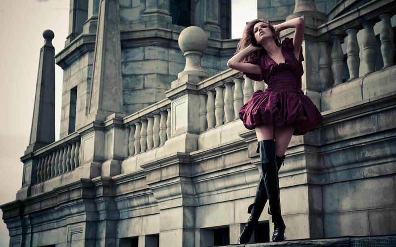 woman in purple dress on balcony