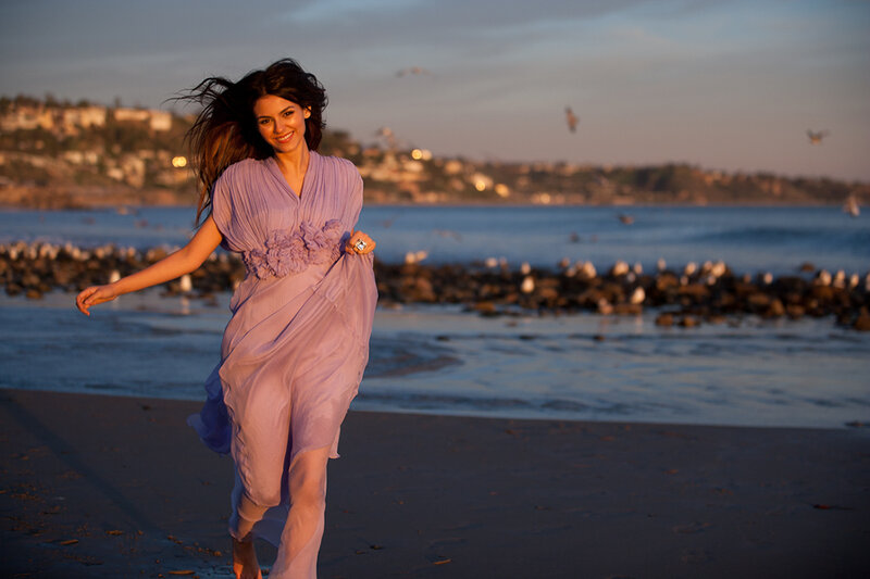 Woman in purple dress on beach