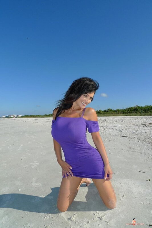 Woman in purple dress on beach