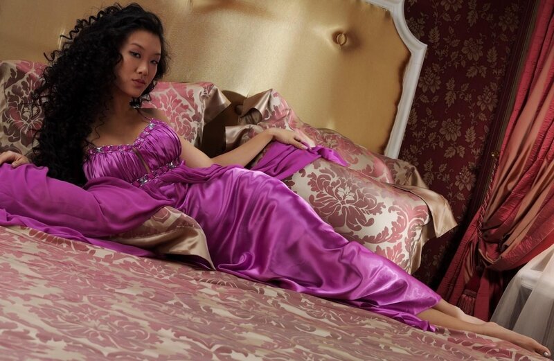 woman in purple dress on bed