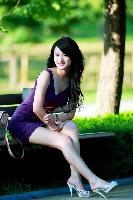 Woman in purple dress on bench