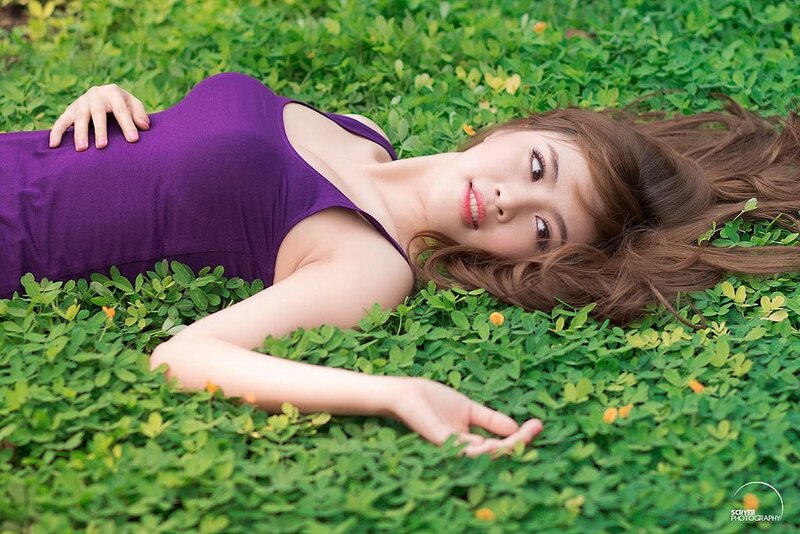 Woman in purple dress on grass