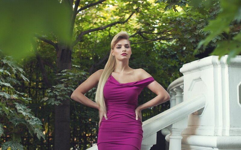 Woman in purple dress outdoors