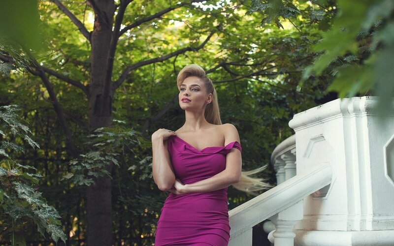 Woman in purple dress outdoors