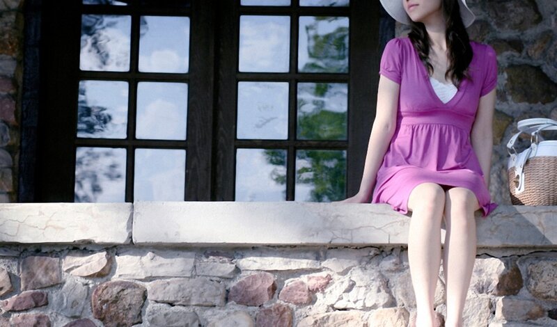Woman in purple dress sitting