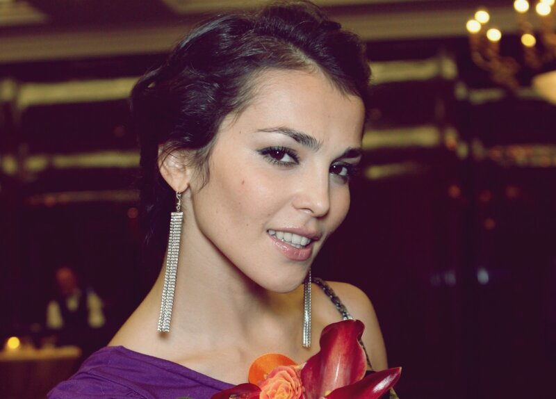 woman in purple dress smiling