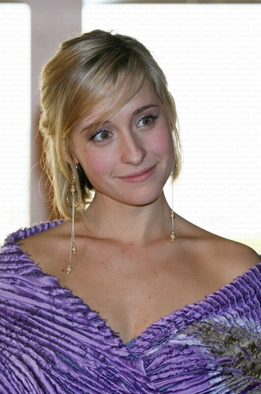 woman in purple dress smiling