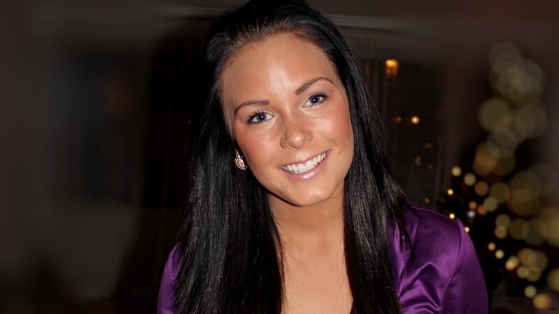woman in purple dress smiling