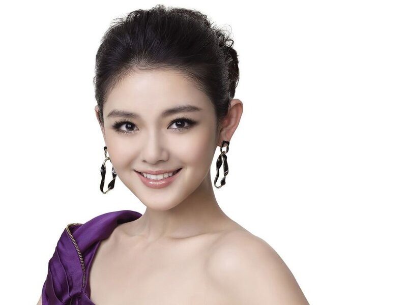 woman in purple dress smiling