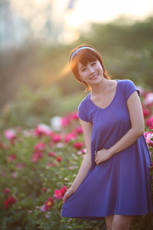 woman in purple dress smiling
