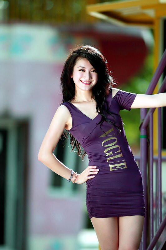 Woman in purple dress smiling