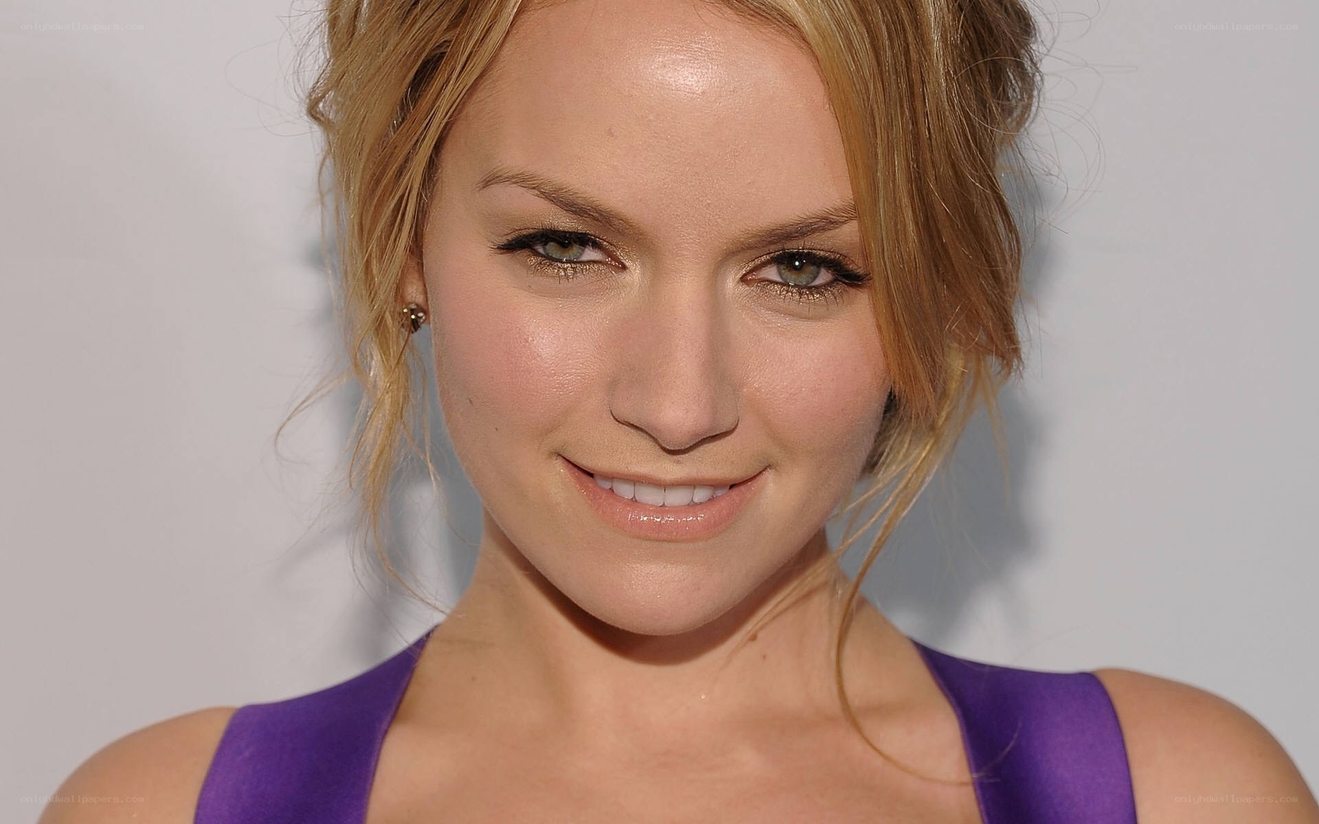 woman in purple dress smiling