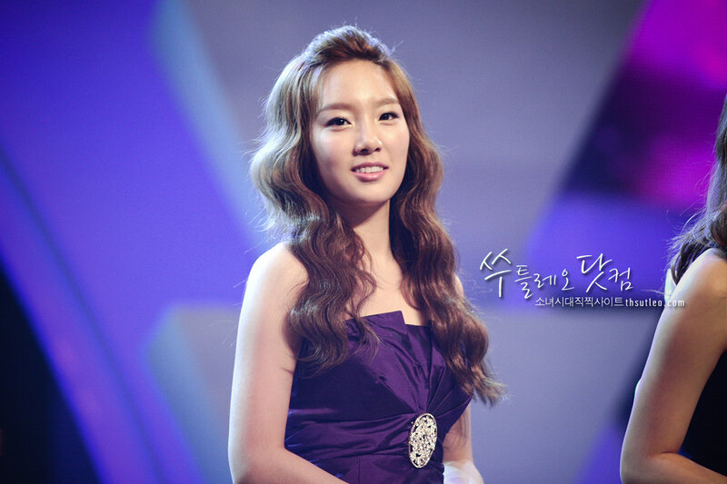 woman in purple dress smiling