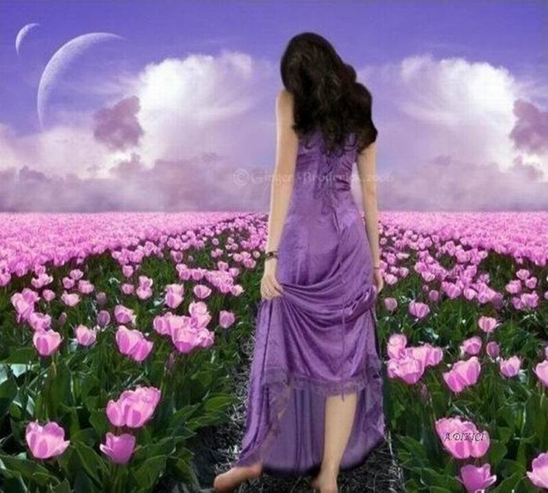 Woman in purple dress walking through tulips