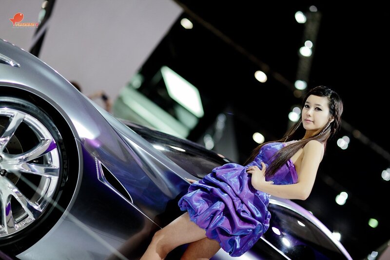 Woman in purple dress with car