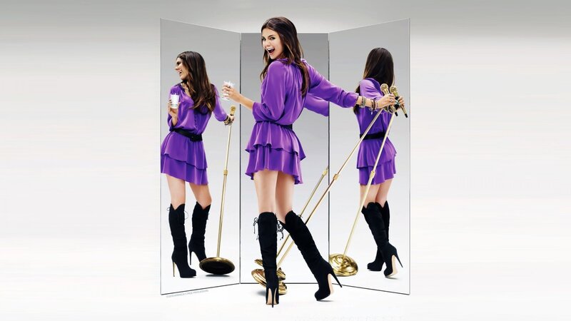 Woman in purple dress with microphones
