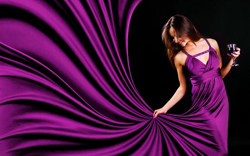 woman in purple dress with wine