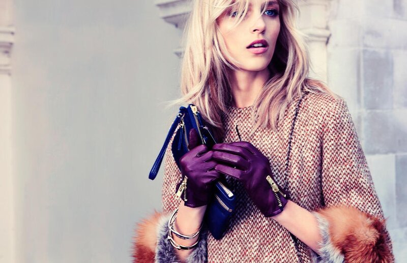 woman in purple gloves holding clutch