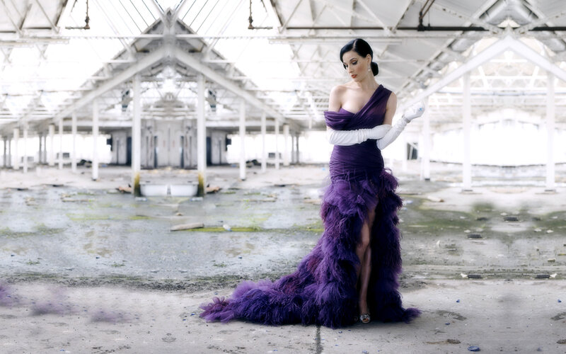 Woman in purple gown in abandoned hall