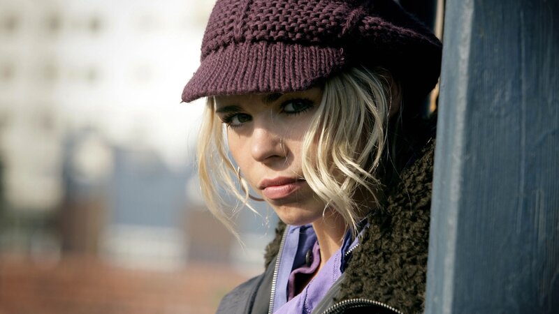 woman in purple hat looking at camera