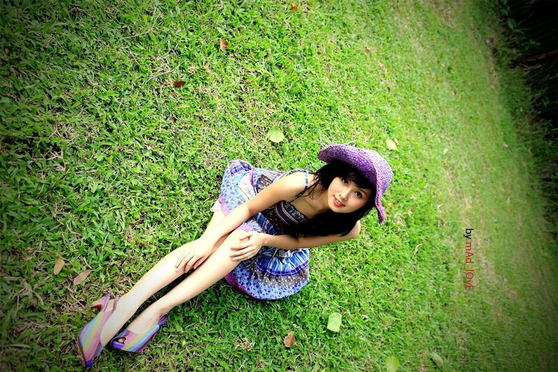 Woman in purple hat on grass