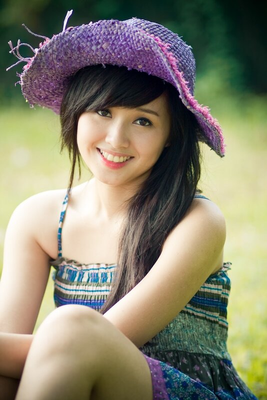 woman in purple hat smiling