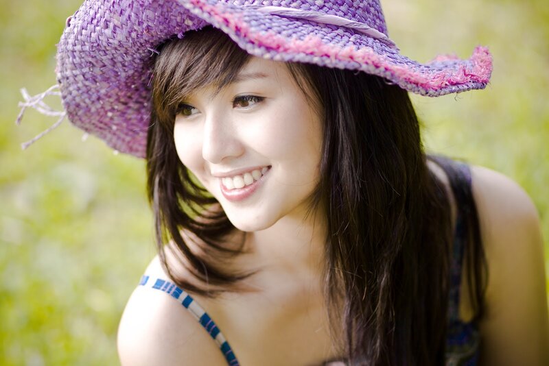 woman in purple hat smiling
