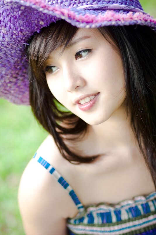 woman in purple hat smiling