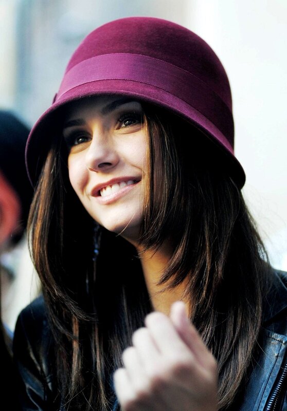 woman in purple hat smiling