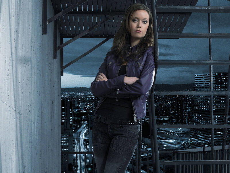 woman in purple jacket on rooftop