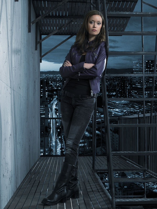 woman in purple jacket on rooftop