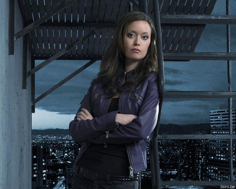 woman in purple jacket on rooftop