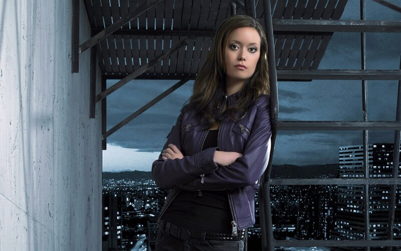 woman in purple jacket on rooftop
